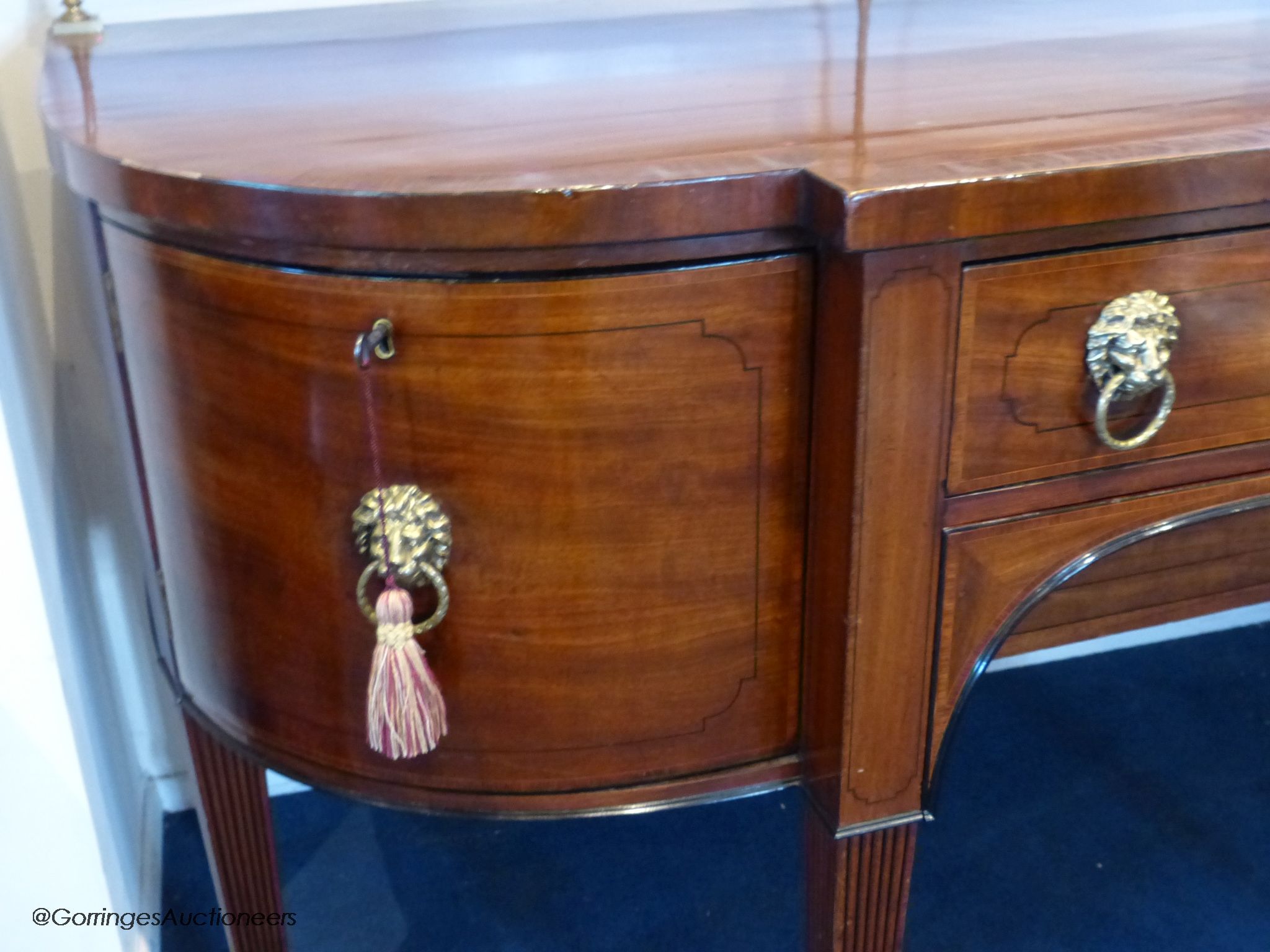 A George III mahogany bow-breakront sideboard, 152cm long, 116.5 cm high to top brass rail, 76 cm deep